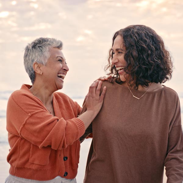 two friends laughing on beach