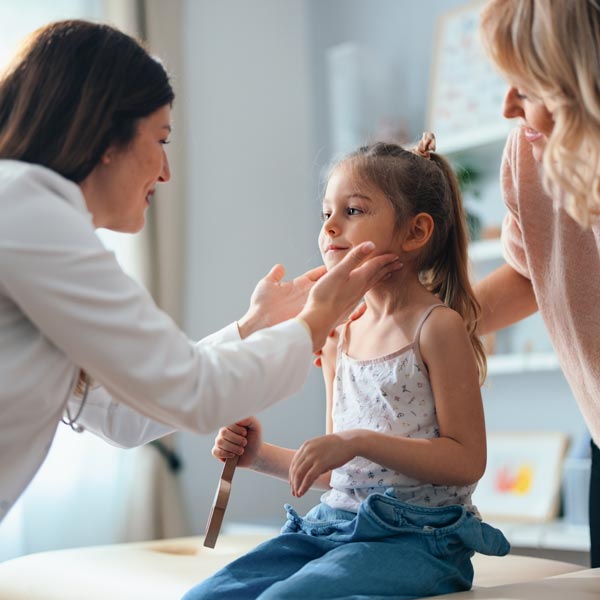 little girl being examined by doctor